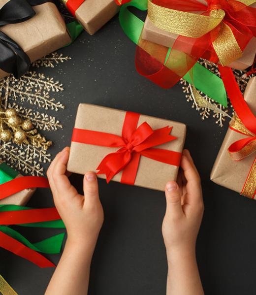 kids hands holding gift wrapped